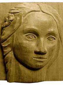 Visage sculpté en haut-relief dans du poirier